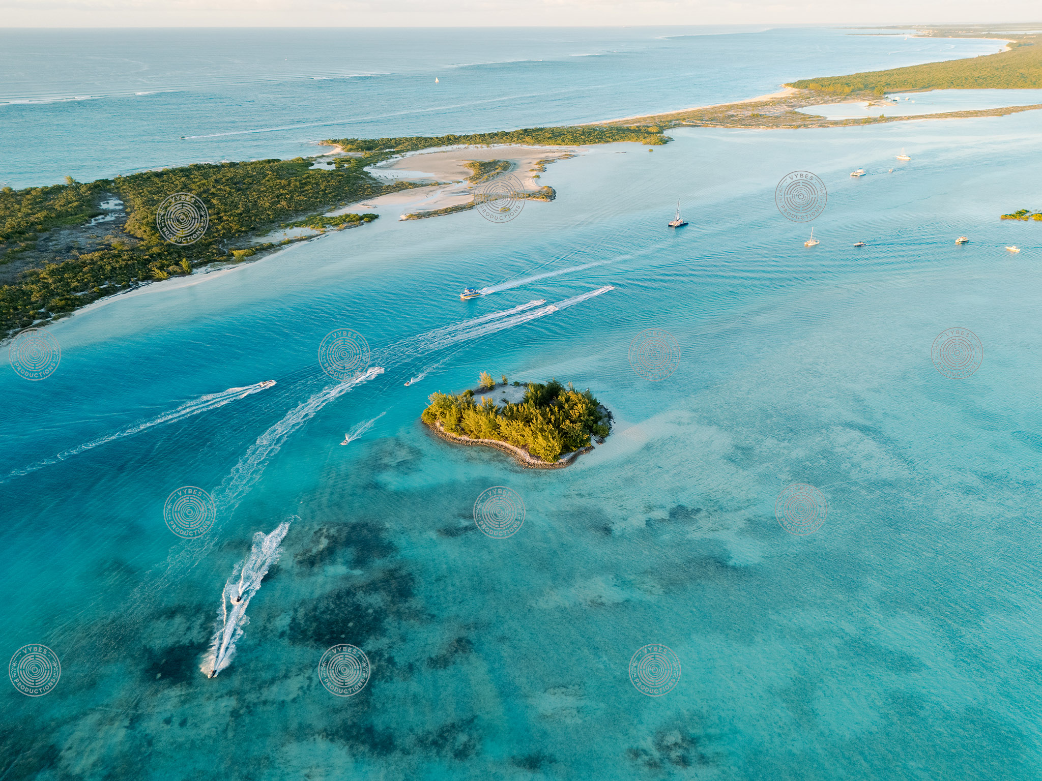 Aerial view of boats and jetskis passing by Star Island