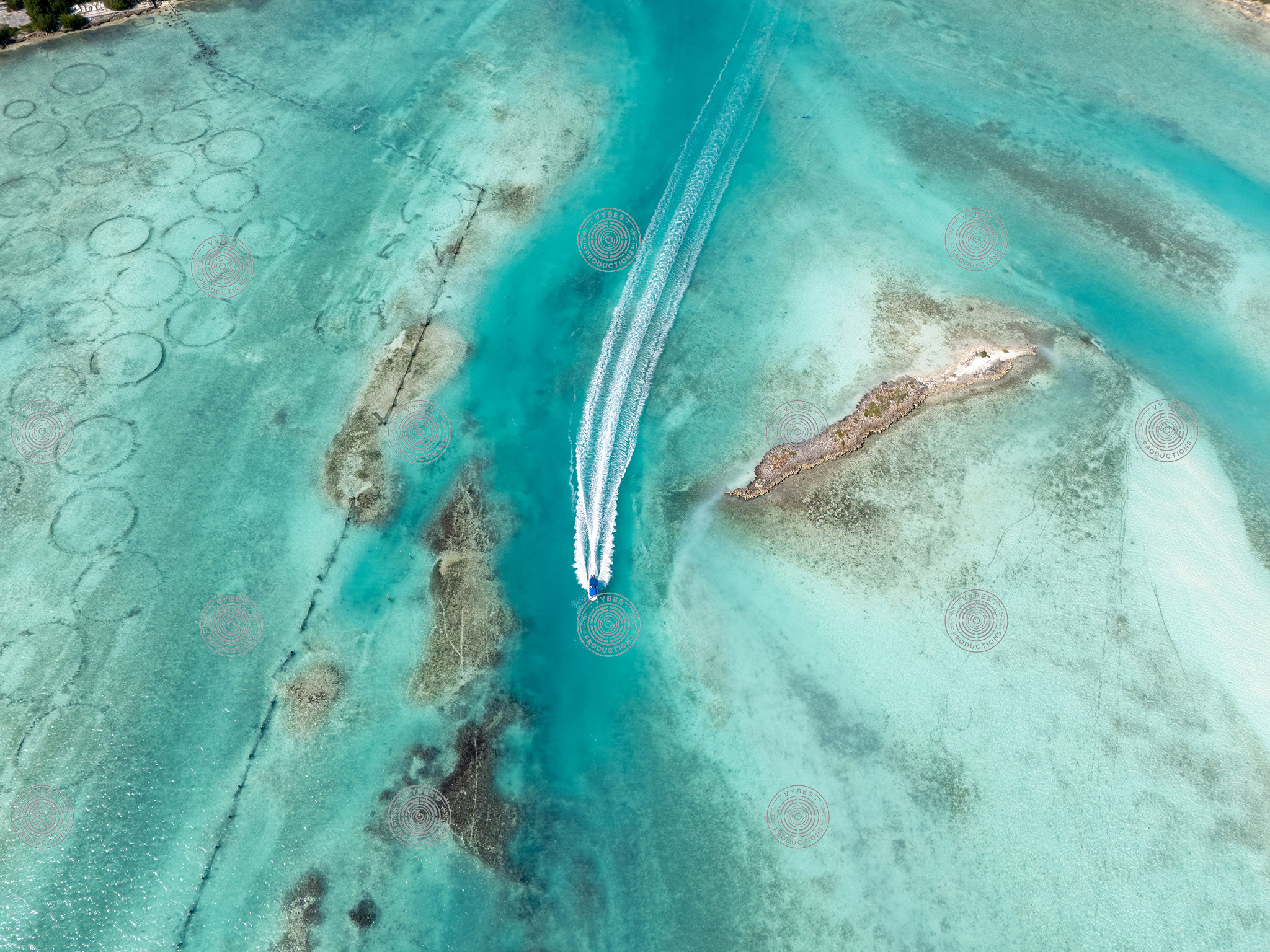 Boat Near Conch Farm Pools in Shallow Turquoise Waters
