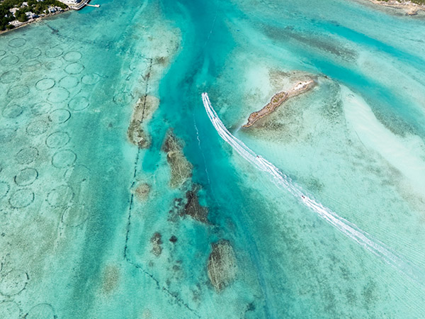 Jetskis going by Conch Farm Pools near Leeward