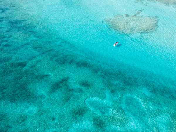 Drone shot of boat in Grace Bay waters