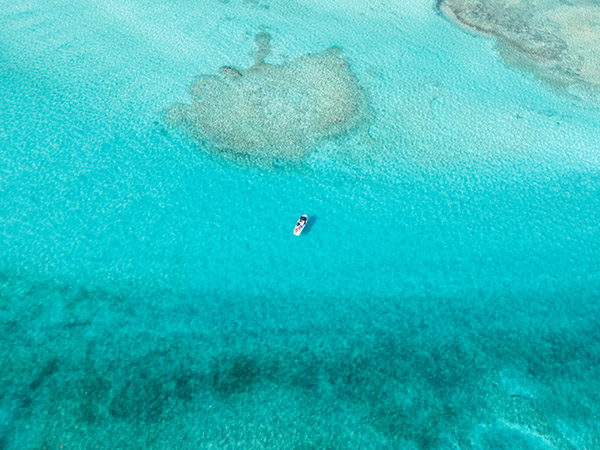 Drone shot of boat in Grace Bay waters