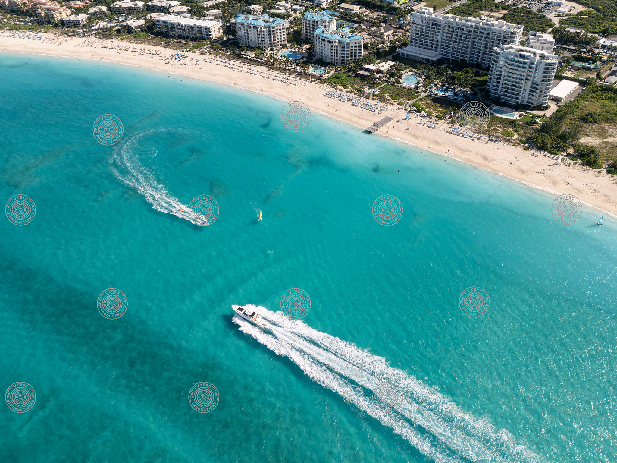 Drone shot of boats passing in front of Ritz-Carlton Resort and Seven Stars Resort