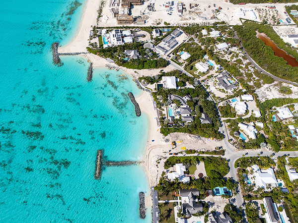 Aerial photo of beachfront groins and luxury homes in Leeward, Turks and Caicos