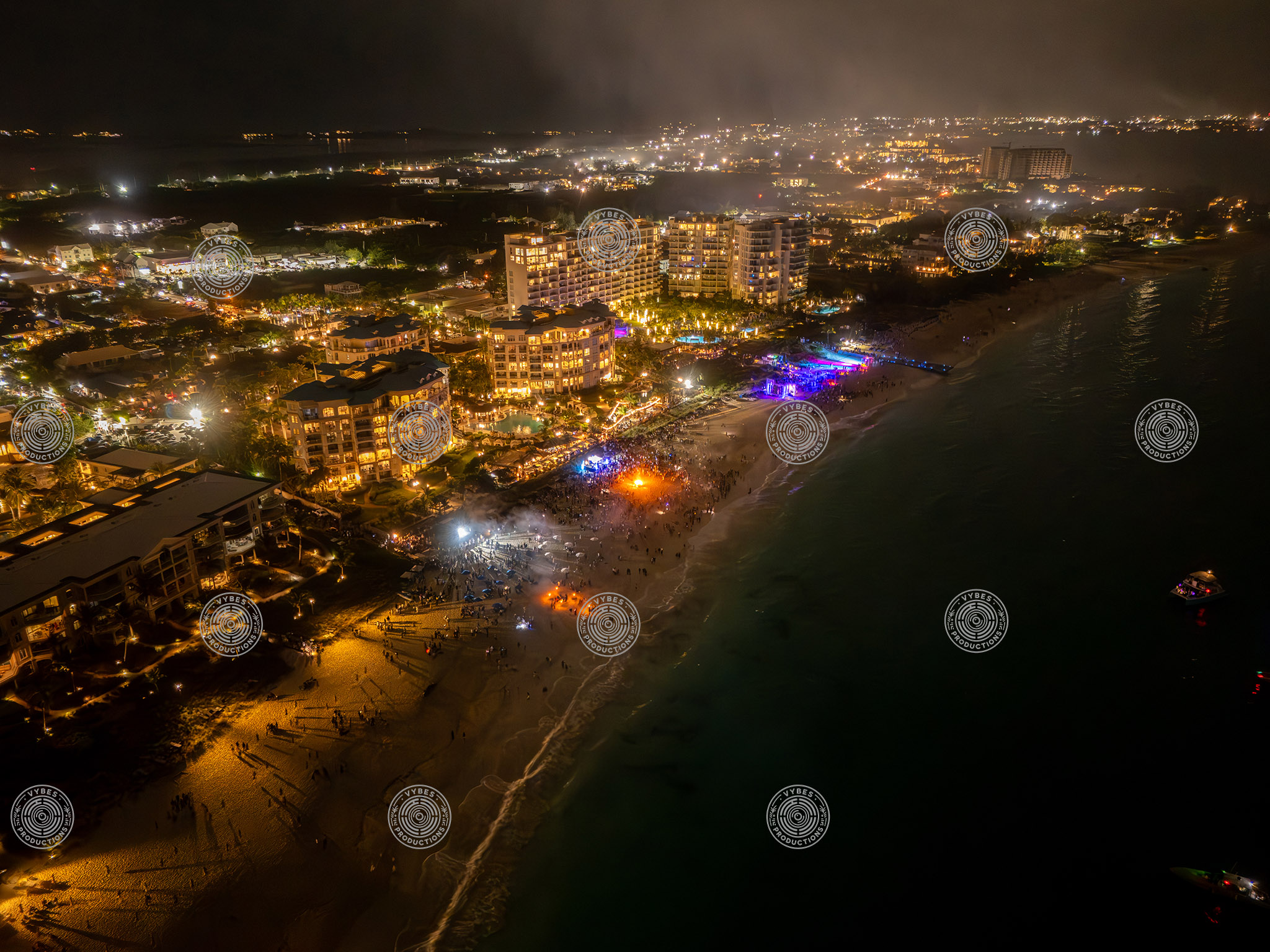 Nighttime drone shot showing Grace Bay Beach during New Years Eve