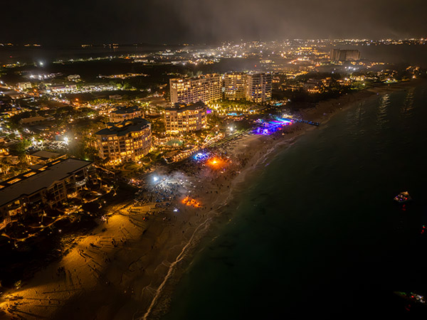 Nighttime drone shot showing Grace Bay Beach during New Years Eve