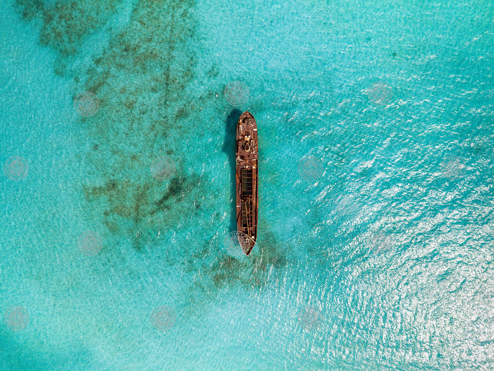 Top-down aerial of La Famille Express shipwreck in turquoise water