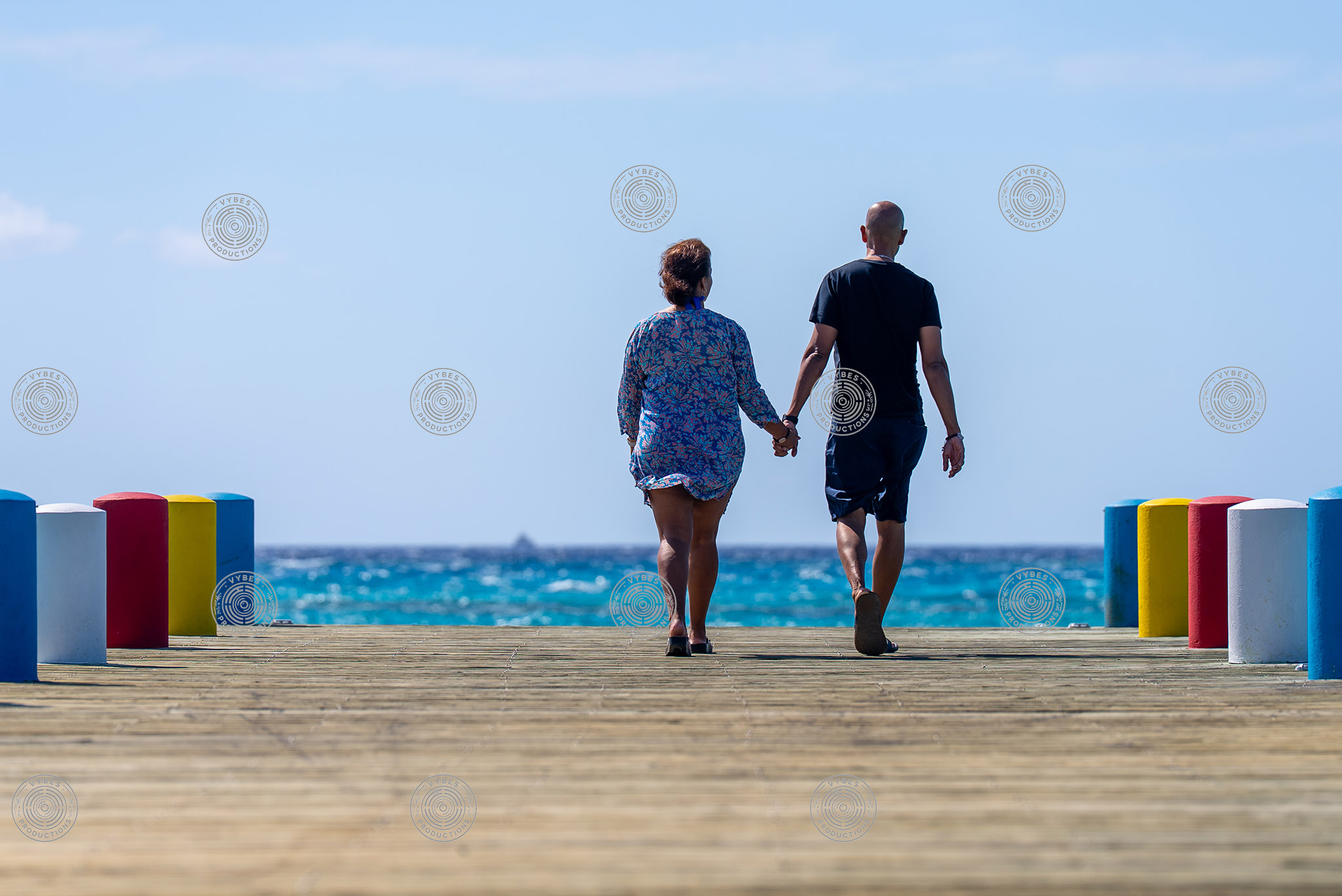 Handheld shot of tourists walking along dock in South Caicos