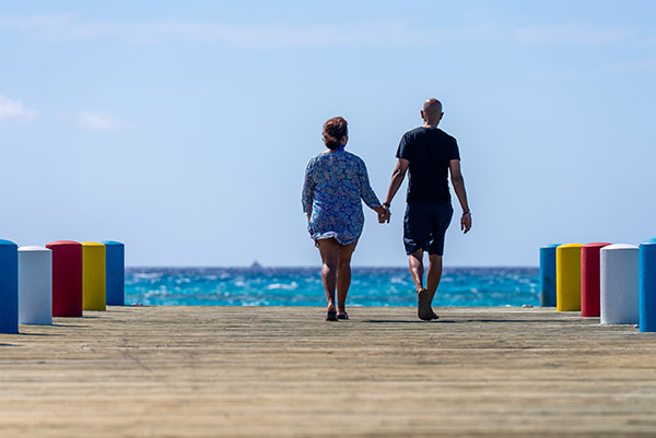 Handheld shot of tourists walking along dock in South Caicos