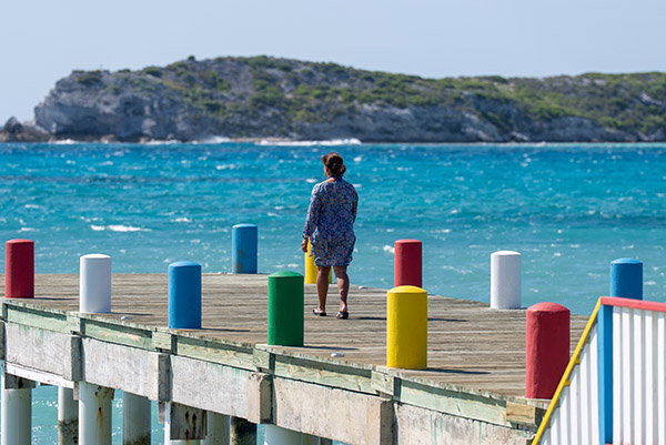 Handheld shot of tourist walking along dock in South Caicos