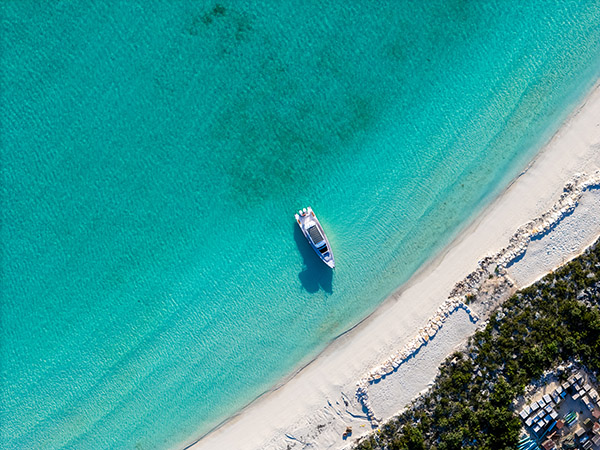 Top down drone shot of yacht on shores in Turtle Tail