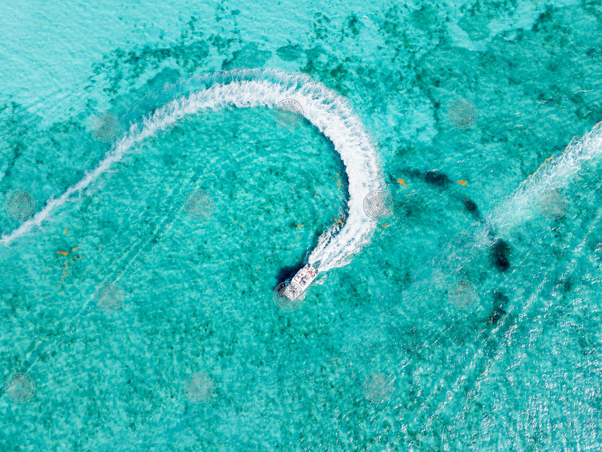 Drone shot of boat turning near Grace Bay Beach