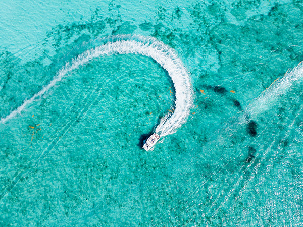 Drone shot of boat turning near Grace Bay Beach