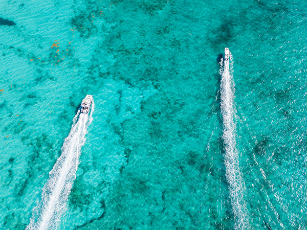 Drone shot of two boats cruising near Grace Bay Beach