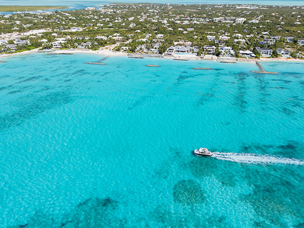 Tour boat cruising near shoreline in Leeward
