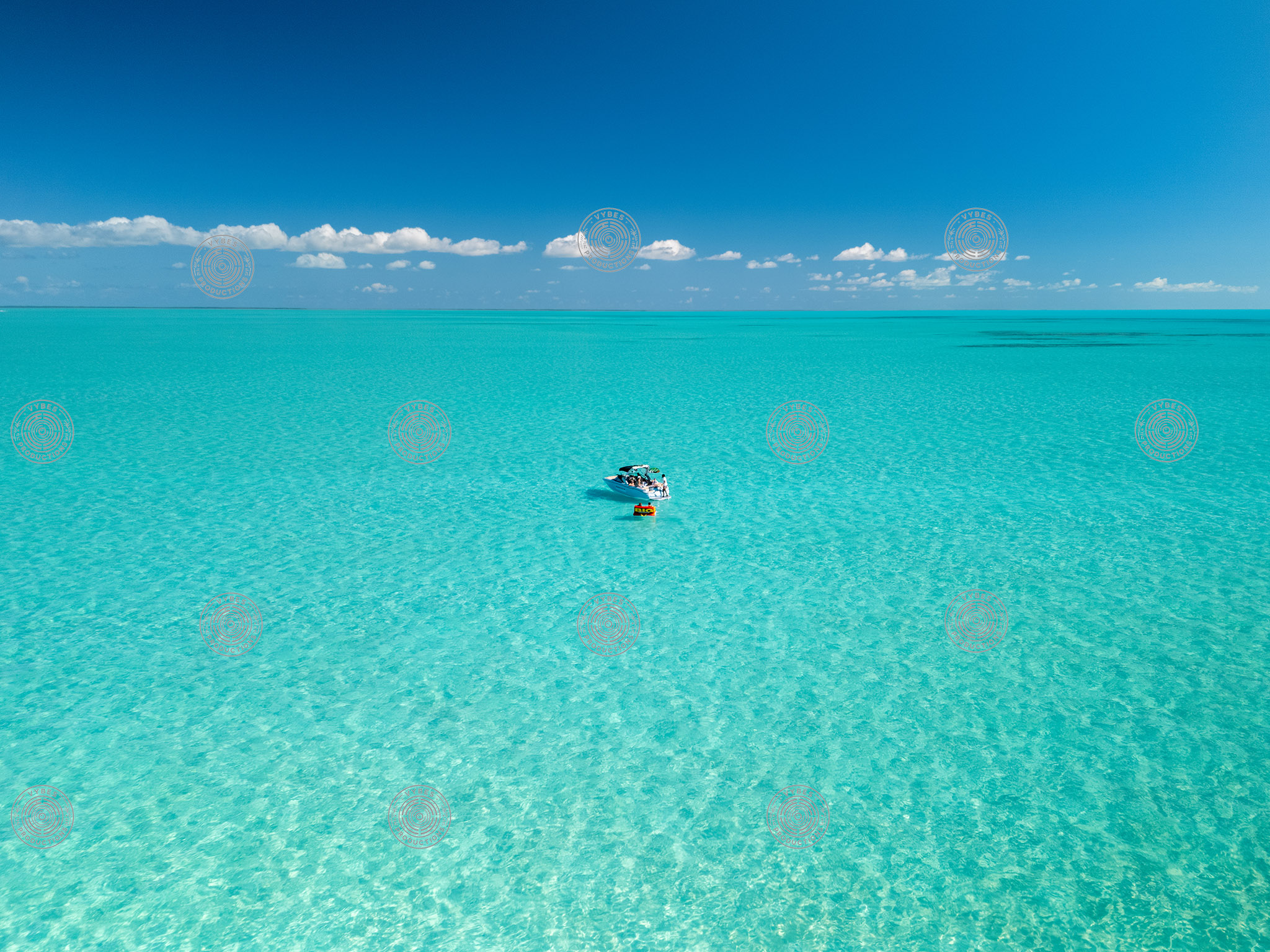 Small boat with tube floating near Long Bay