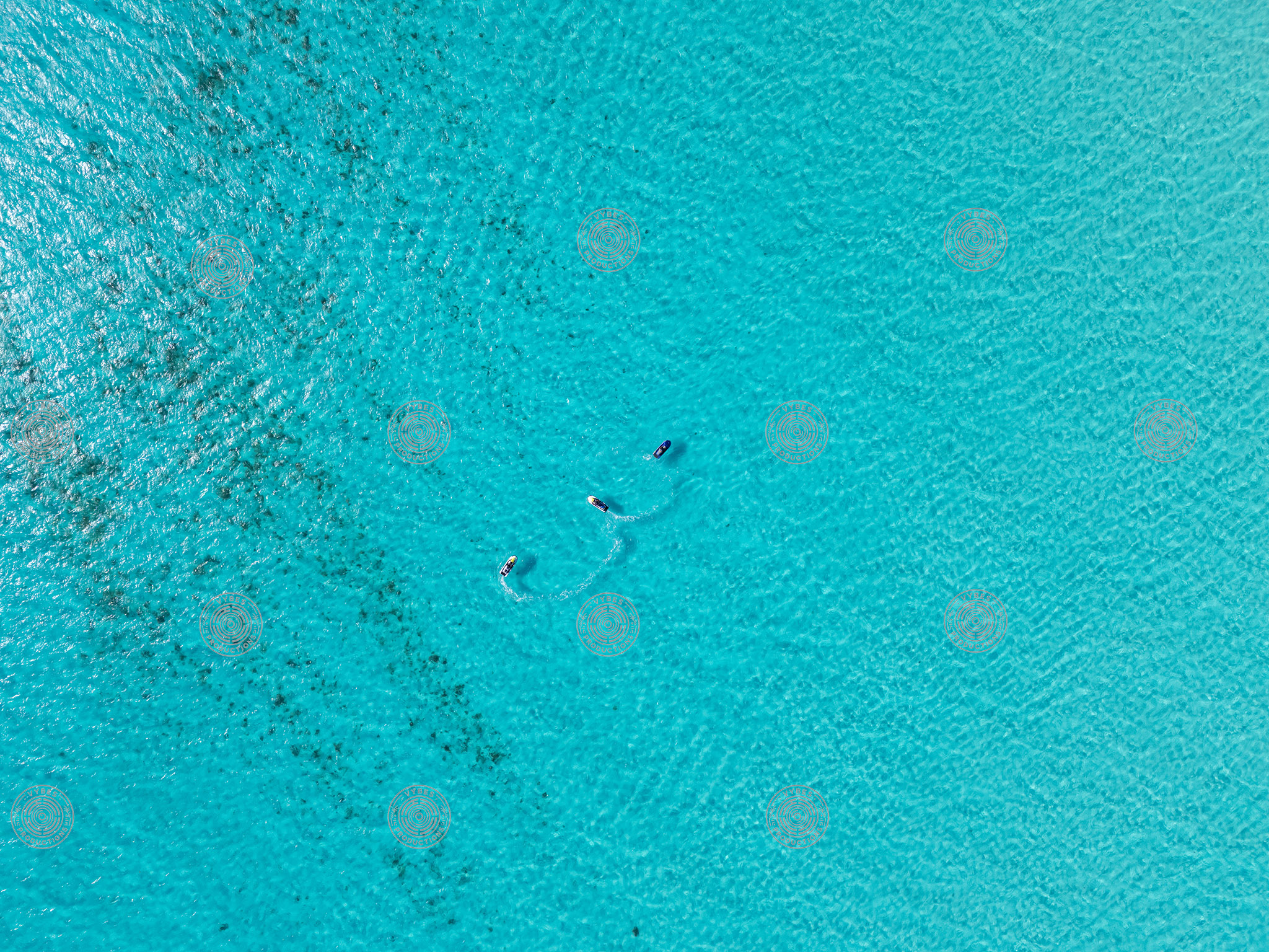 Top down drone shot of 3 jetskis