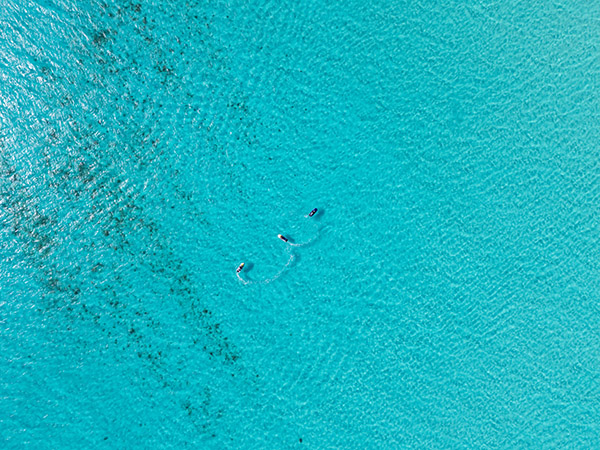 Top down drone shot of 3 jetskis