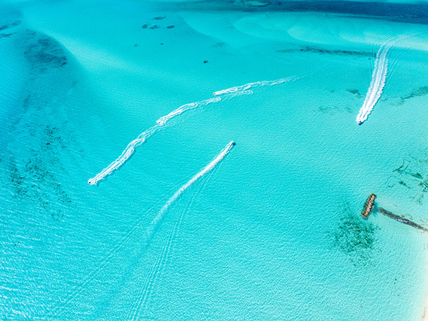 Aerial shot of jetskis and boats cruising