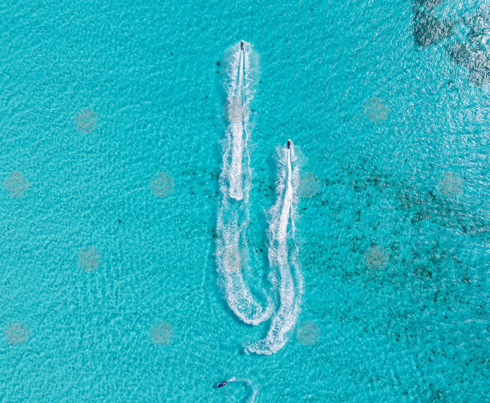Two Jet Skis Creating Wake Trails in Crystal Clear Ocean