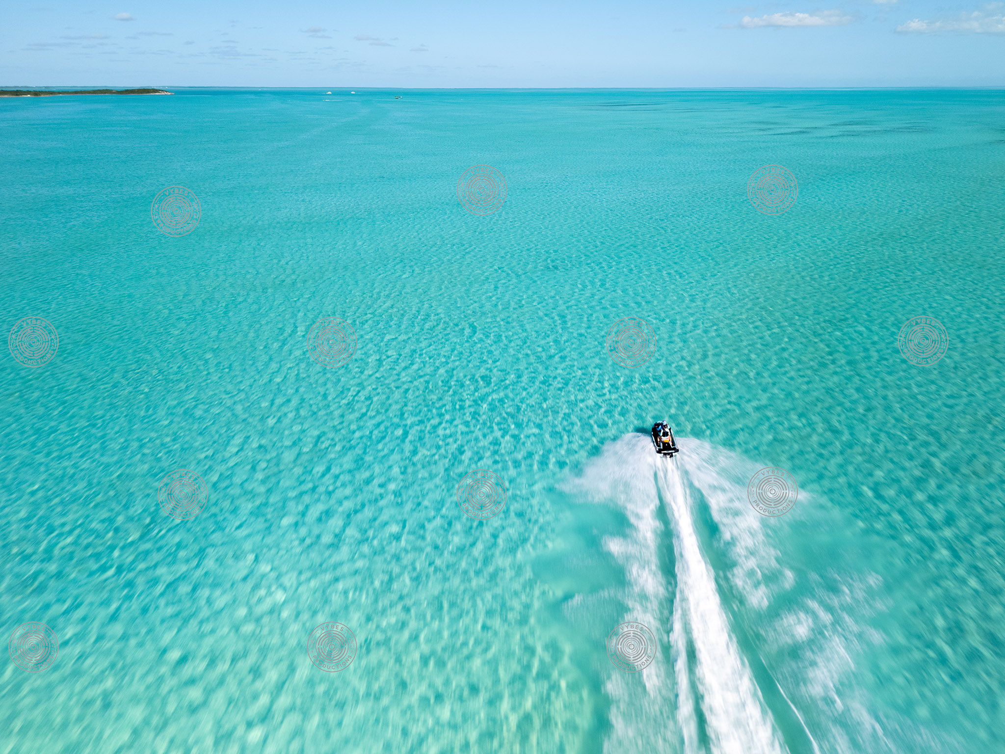 Single jetski racing through shallow waters in Long Bay