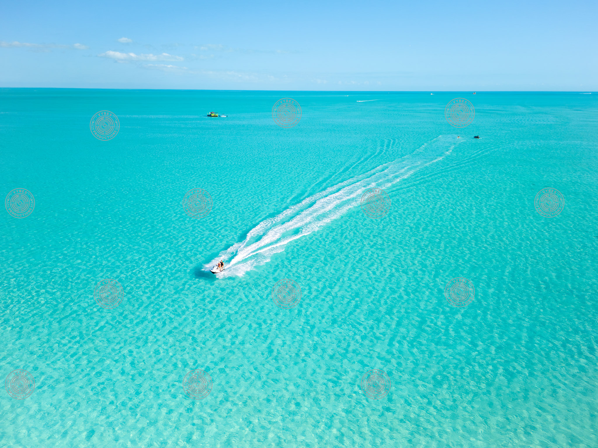 Wide Ocean View with Jet Ski and Ripples in Shallow Blue Water