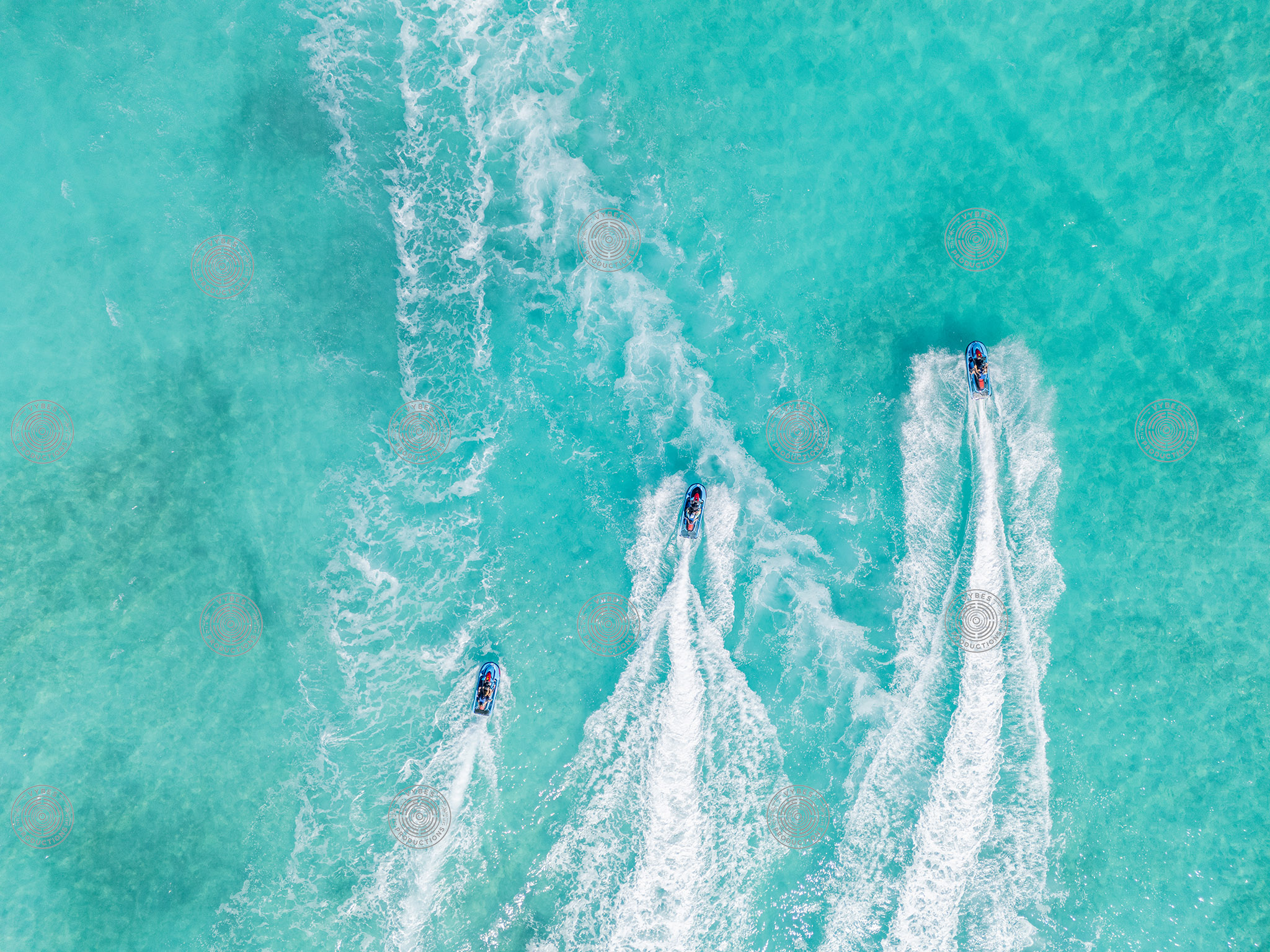 Three Jet Skis in Motion over clear water