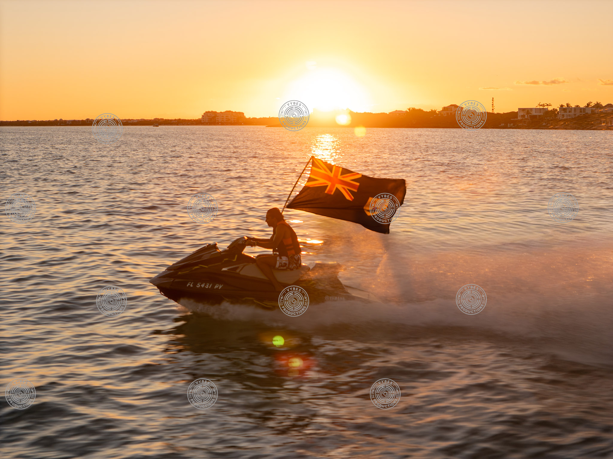 Close-up drone shot of a jetski carrying official TCI flag