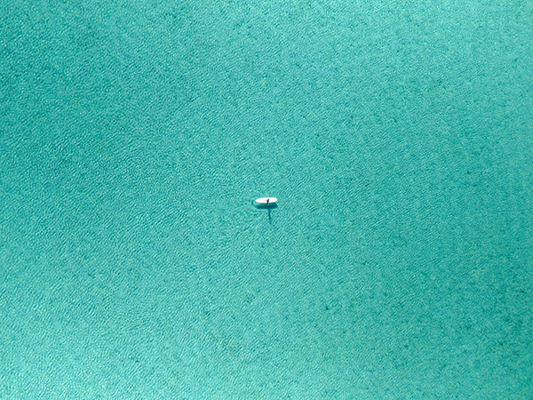 Paddleboard Floating Alone in Calm Turquoise Waters