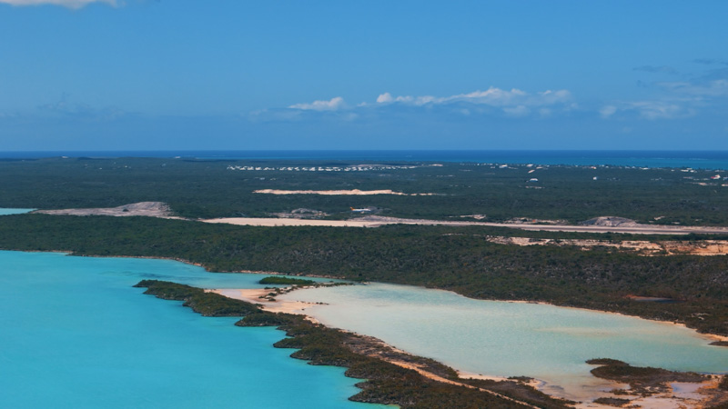 Aerial view of small plane landing at PLS Airport