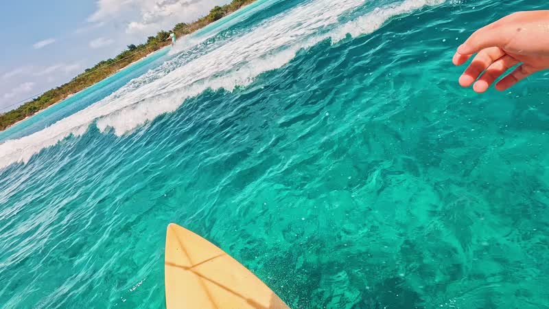 Action camera shot of tourist wakeboarding behind wakeboat