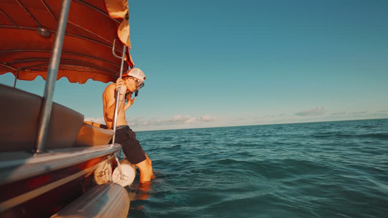 Static shot of snorkelers entering water