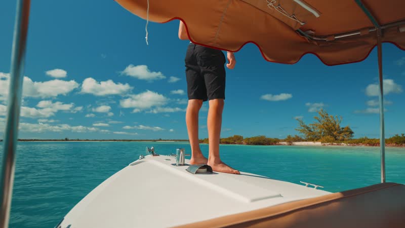 Handheld shot of tourist preparing to jump off boat
