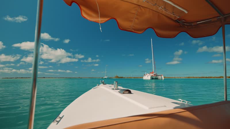 Handheld shot of boat passing by Blue Haven Marina and other boats
