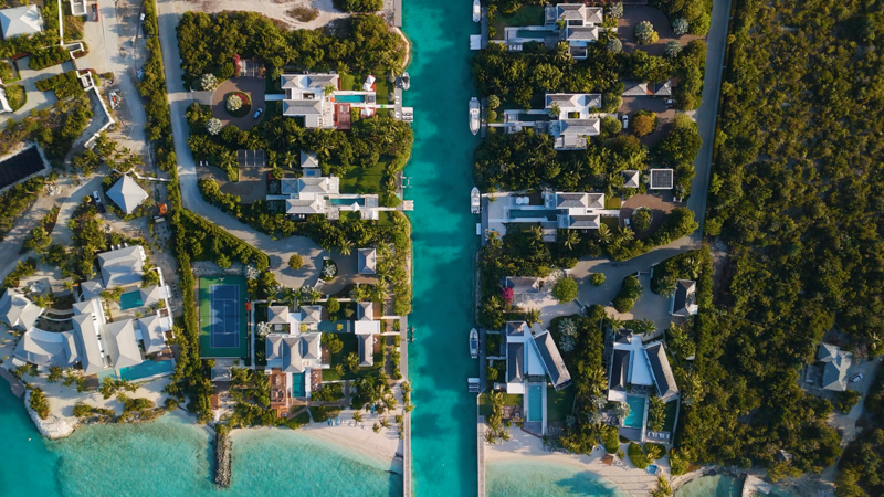 Top down drone view of luxury villas lining a canal in Leeward