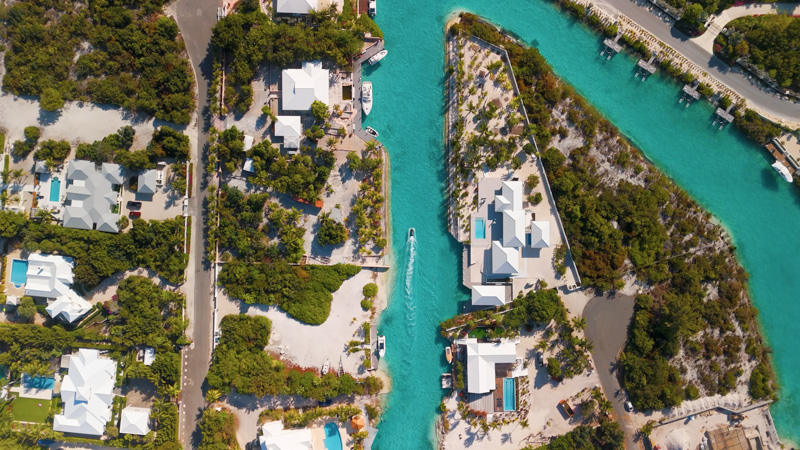 Top down drone shot of jetski moving slowly through canal in Leeward