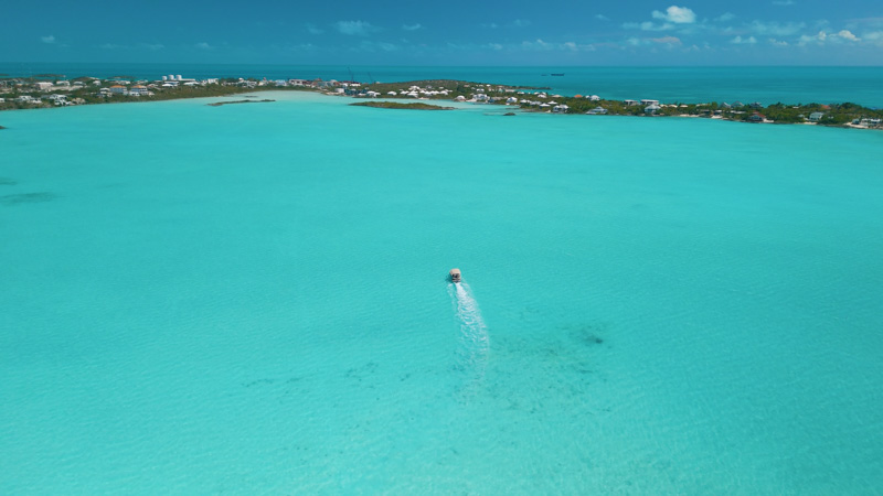 Aerial view of small boat moving within Chalk Sound