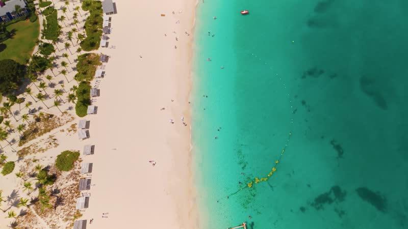 Drone shot panning up to reveal Grace Bay Beach