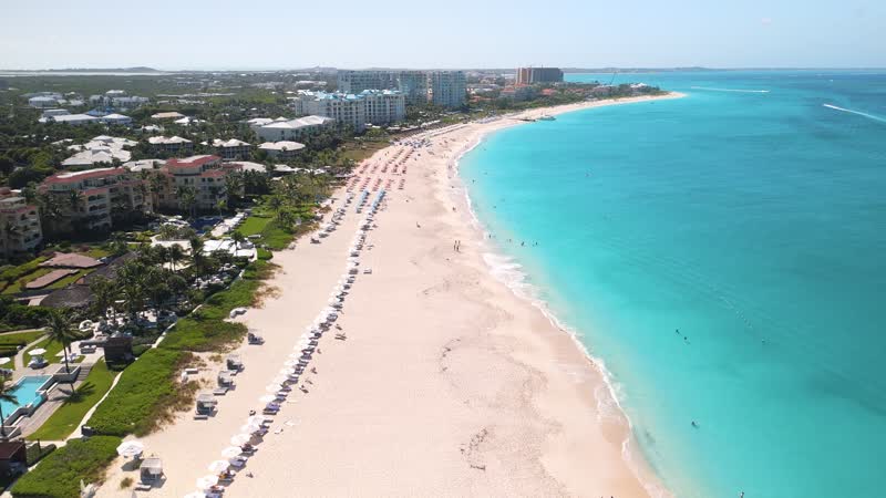 Drone shot going along downtown Grace Bay Beach strip
