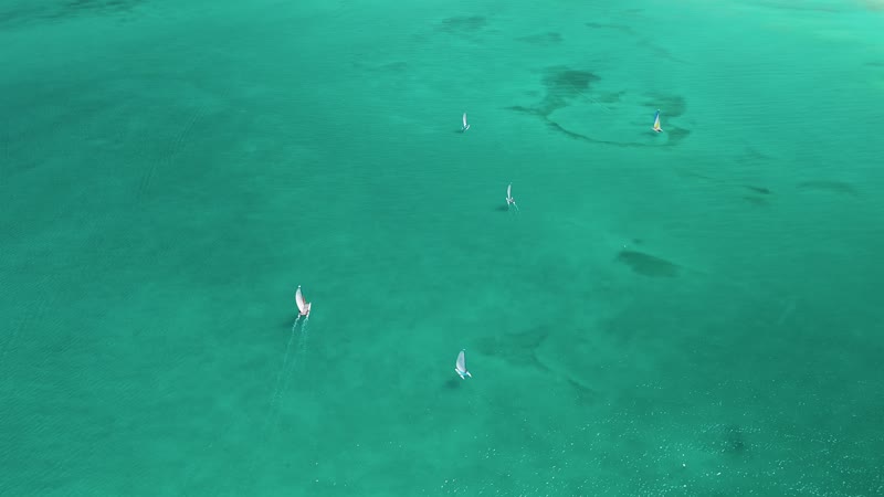Drone shot of sailboats moving through Grace Bay waters