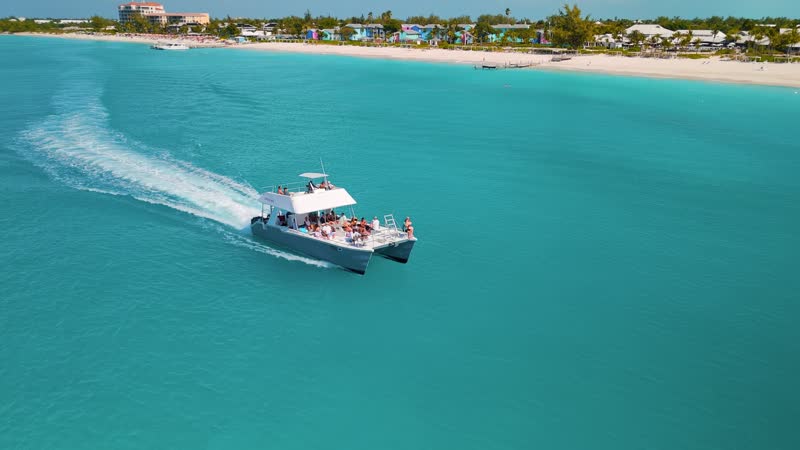 Dynamic drone shot following catamaran off of Grace Bay Beach