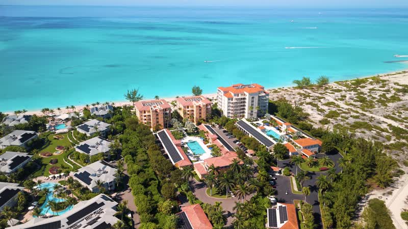 Drone panning shot of The Tuscany and The Venetian resorts in Grace Bay