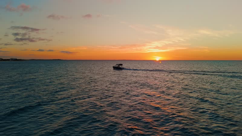 Sunset drone shot of boat in Grace Bay waters