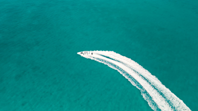 Drone shot of yacht arriving at Grace Bay Beach