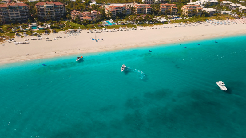 Drone shot of yacht arriving at Grace Bay Beach