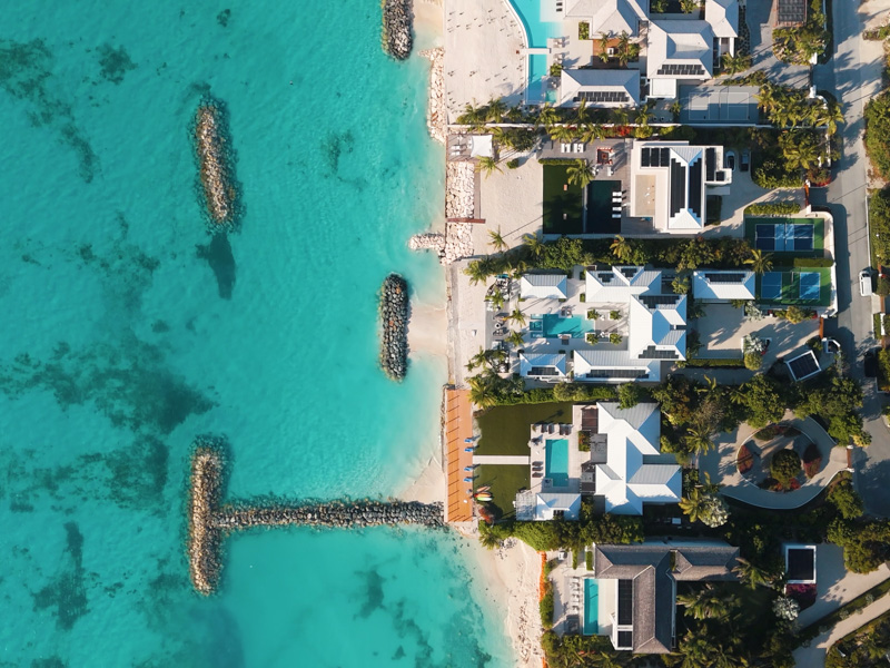 Overhead drone shot over luxury beachfront villas in Leeward along Grace Bay Beach