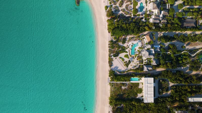 Top down drone shot of luxury villas and beach in Leeward