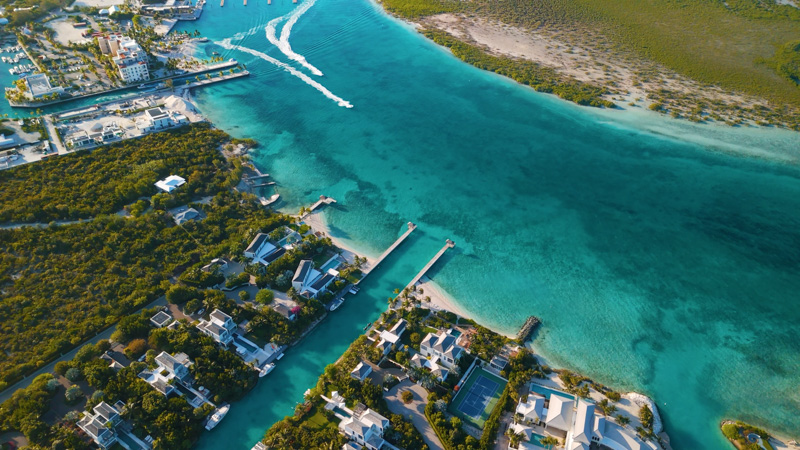 Upward drone shot of canals in Leeward opening up to Blue Haven Marina