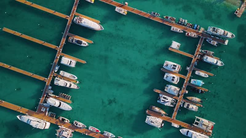 Top down rotating shot of boats docked at Blue Haven Marina
