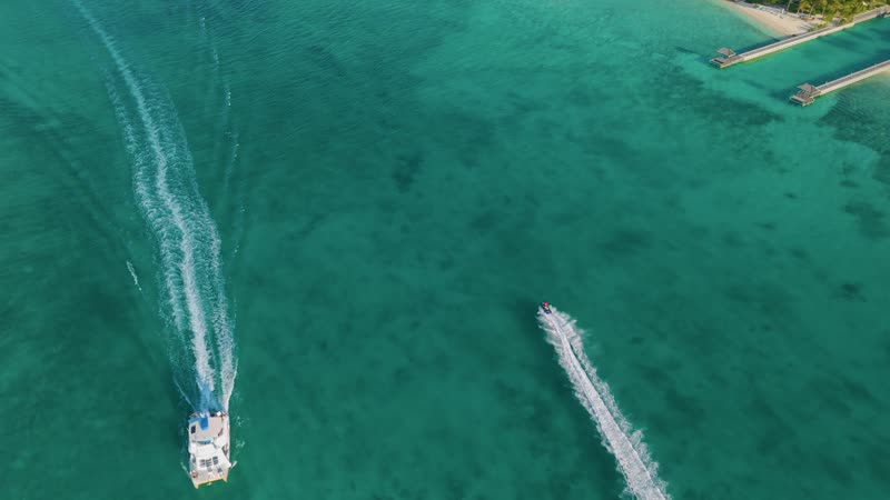 Drone shot following jetski moving through Leeward waters
