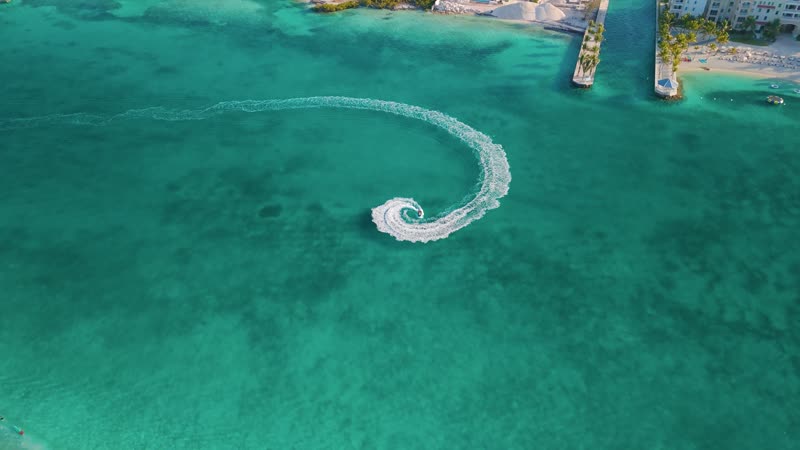 Dynamic drone shot of jetski doing donuts